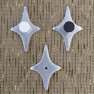 May include: Three silver star-shaped knobs with different colored centers. The knobs have a white, black, and a silver center.