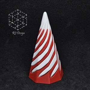 May include: A decorative, cone-shaped object with a red base and white and red striped design. The top is white and pointed. The object has the text "RJ Design" and a geometric logo.