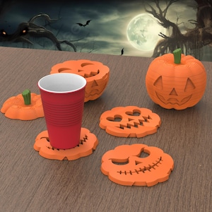 May include: A red plastic cup sits on a pumpkin-shaped coaster, surrounded by other orange pumpkin coasters and a carved pumpkin. The Halloween-themed items are on a wooden surface, with a spooky background.