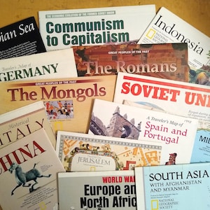 May include: A collection of vintage National Geographic maps featuring various countries and regions, including Germany, The Mongols, The Romans, Soviet Union, Spain and Portugal, Middle East, South Asia, and The Old City of Jerusalem. The maps are in various colors and have a vintage look.