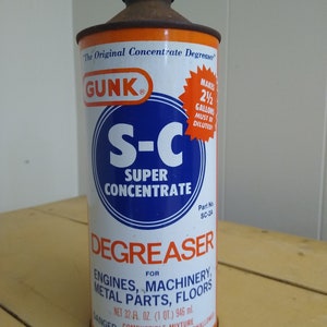 May include: A vintage orange and blue can of GUNK S-C Super Concentrate Degreaser. The can is labeled "The Original Concentrate Degreaser" and "Makes 2 1/2 Gallons Must Be Diluted!" The can also states "For Engines, Machinery, Metal Parts, Floors" and "Net 32 fl. oz. (1 qt.) 946 ml."