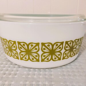 May include: White casserole dish with a green floral pattern and a clear glass lid.