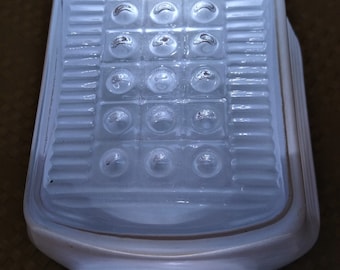 May include: White frosted glass ceiling light fixture with a rectangular shape and a grid of round, raised, clear glass circles.