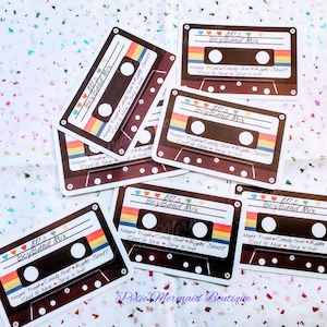May include: A set of six brown cassette tape stickers with rainbow stripes and the text "80's Boyband Mix" and "Happid Treet Candy Girl Right Stuff Ceel It New Step It Girl".