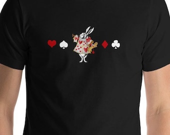 May include: A black t-shirt with a white rabbit wearing a red and white suit and holding a playing card. The rabbit is surrounded by four playing card symbols: a heart, a spade, a diamond, and a club.