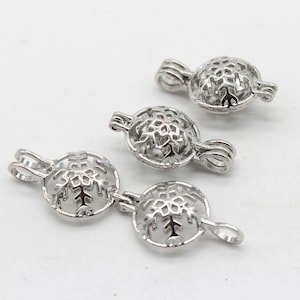 May include: Three silver snowflake charm pendants with a round, openwork design. The pendants have a loop at the top for attaching to a necklace or bracelet.