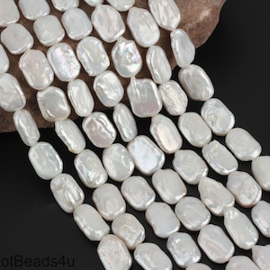May include: A strand of white baroque freshwater pearls, each pearl is a unique oval shape with an iridescent sheen.