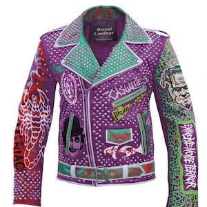May include: Purple leather jacket with a green and white lining. The jacket is covered in silver studs and has various patches sewn on, including a scorpion, a skull, and a band logo. The text "The Casualties" is written on the front of the jacket.