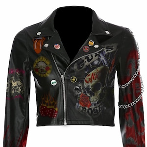 May include: Black cropped leather jacket with a zip fastening, decorated with patches, pins, and graphic prints. Features a skull and rose design, a red and white tongue logo, and chain detailing on the shoulder.