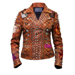 May include: A brown leather jacket with a leopard print design. The jacket is covered in silver studs and has several patches sewn on, including a snake, a skull, and a cross. The jacket has a zip closure and two pockets on the front.