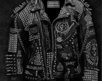 May include: A black leather jacket with silver studs and spikes. The jacket has several patches, including "Comet Sun", "Bloodline", "Knargh", "Smart", "Gold Coin", and "Awaiting Fear".