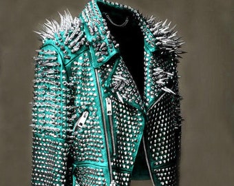 May include: A teal leather jacket with silver studs and spikes. The jacket has a cropped style and a zipper closure.