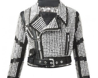 May include: A black leather jacket with silver studs covering the entire surface. The jacket has a zipper closure, a belt at the waist, and long sleeves.