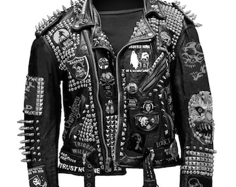 May include: Black leather jacket heavily adorned with silver studs and spikes. Patches with skull and other graphics are sewn on the jacket. The jacket has a zipper closure and a belt. Text on the jacket includes "HAUNTED HOME" and "BECAUSE YOU ARE".