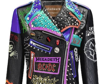 May include: Black leather jacket with colorful patches and silver studs. Features band logos like AC/DC and Megadeth, along with the text "Leftover Crack" and "Oxymoron". The jacket has a purple zipper and accents, with a studded collar.