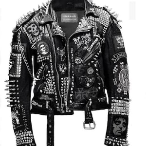 May include: A black leather jacket with silver studs and spikes. The jacket has several patches sewn on, including a band patch that says "Pop Punks Not Dead".