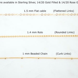 May include: Three gold chains with different link styles and sizes. The top chain is 1.5 mm flat cable with flattened links. The middle chain is 1.4 mm rolo with rounded links. The bottom chain is 1 mm beaded chain with curb links. Chains are available in sterling silver, 14/20 gold filled, and 14/20 rose gold filled.