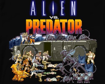 Könnte beinhalten: Schwarzes T-Shirt mit einer farbenfrohen Grafik, die eine Kampfszene und den Text "ALIEN vs. PREDATOR" in Blau und Orange zeigt. Die Grafik zeigt Charaktere und Fahrzeuge aus den Alien- und Predator-Franchises.