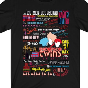 May include: Black t-shirt with a colourful graphic design featuring the text "Thompson Twins" and song titles such as "Hold Me Now", "Love on Your Own", "Get That Love", "King for a Day", "Roll Over", "Sugar Daddy", and "Play with Me (Jane)".