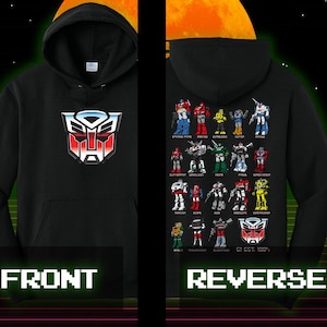 May include: Black hooded sweatshirt with the Autobot logo on the front. The reverse side features various Transformers characters. The sweatshirt has a front pocket and a drawstring hood. The word "FRONT" is printed below the front image, and "REVERSE" is printed below the reverse image.