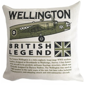May include: Square cushion in cream fabric, featuring a green illustration of a Vickers Wellington bomber. Text reads "WELLINGTON" and "BRITISH LEGEND", with a Union Jack flag. A WWII theme.