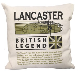 May include: A white cushion with a green and black illustration of a Lancaster bomber, the text "LANCASTER BRITISH LEGEND" and a Union Jack flag. The text below the illustration reads: "The "Lanc" was the RAF's WWII principal heavy bomber, and the only aircraft capable of carrying the 22,000lb "Grand Slam" bomb. It excelled in both daylight and night-time bombing, and its fame was elevated further by the "Bouncing bomb" "Dam Busters" raids in the Ruhr Valley in 1943."