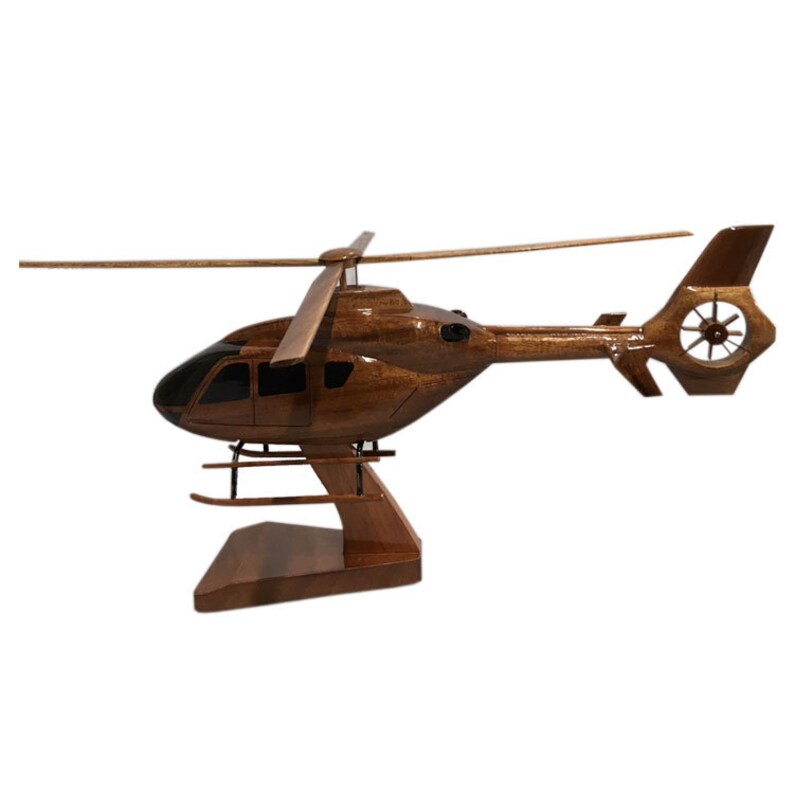 May include: A wooden model of a brown helicopter with a black cockpit and a brown wooden stand.