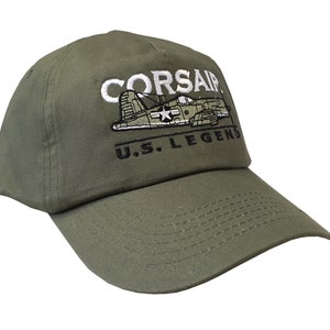 May include: A green baseball cap with an embroidered image of a Corsair aircraft and the text "CORSAIR U.S. LEGEND".