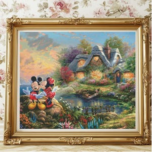 May include: A painting of Mickey Mouse and Minnie Mouse kissing in front of a cottage with a lake and a bridge in the background. The sky is a soft blue with pink and orange clouds. The cottage is a light brown with a thatched roof and a white picket fence.
