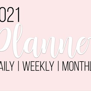 May include: A pink and white planner with the text "2021 Planner" and "DAILY | WEEKLY | MONTHLY" in black text. The planner has a calendar with months of the year listed on the right side.