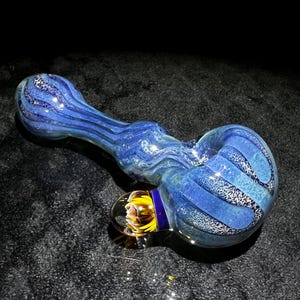 Large and thick color changing glass hand pipe with fume and frit, clear line work, and large implosion marble in metallic blues