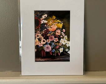 May include: A framed print of a still life painting featuring a bouquet of colorful flowers in a vase. The flowers include pink, white, yellow, and purple blooms. The background is a dark green.