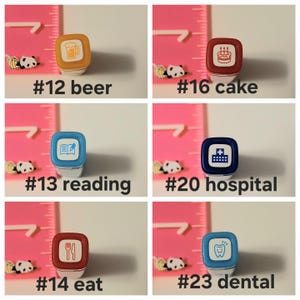 May include: A set of ten colorful rubber stamps with various images, including a beer mug, a cake, a book with a pen, a hospital building, a fork and knife, and a tooth. Each stamp is labeled with a number and a word describing the image.