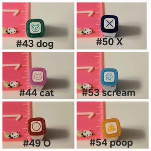 May include: Six different colored square stamps with various designs. The stamps are numbered 43, 44, 49, 50, 53, and 54. The designs include a dog, a cat, a circle, an X, a screaming face, and a poop emoji.
