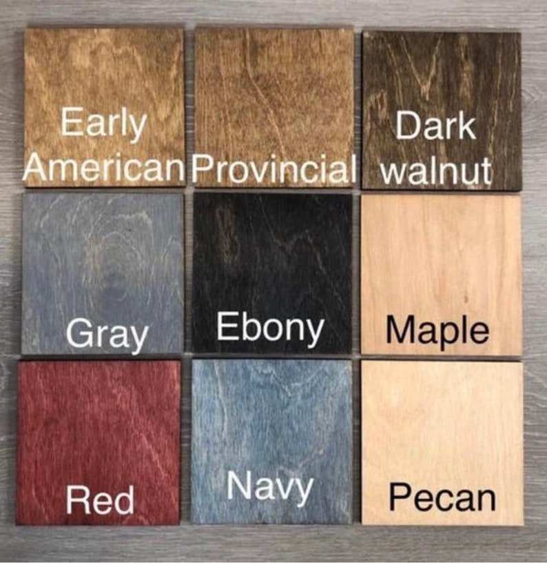May include: Nine wood stain samples in a grid pattern. The stains are labeled: Early American, Provincial, Dark Walnut, Gray, Ebony, Maple, Red, Navy, and Pecan.