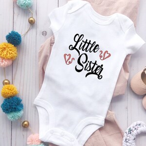 White Baby Bodysuit With &quot;Little Sister&quot; In Black Lettering