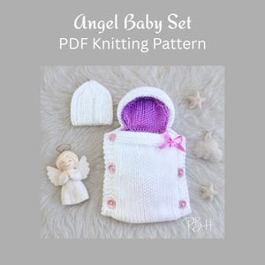 May include: A white knitted baby set, including a hat and sleeping bag with a purple interior and pink details. The image also shows an angel figurine and star decorations. The text on the image says "Angel Baby Set PDF Knitting Pattern."