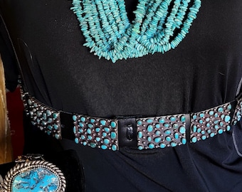 Vintage Navajo Concho belt featuring sterling silver with turquoise clusters. Southwestern wear.