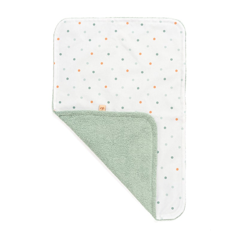 May include: A soft, green and white baby blanket with a polka dot pattern. One side is made of a soft, plush fabric and the other side is made of a smooth, cotton fabric.