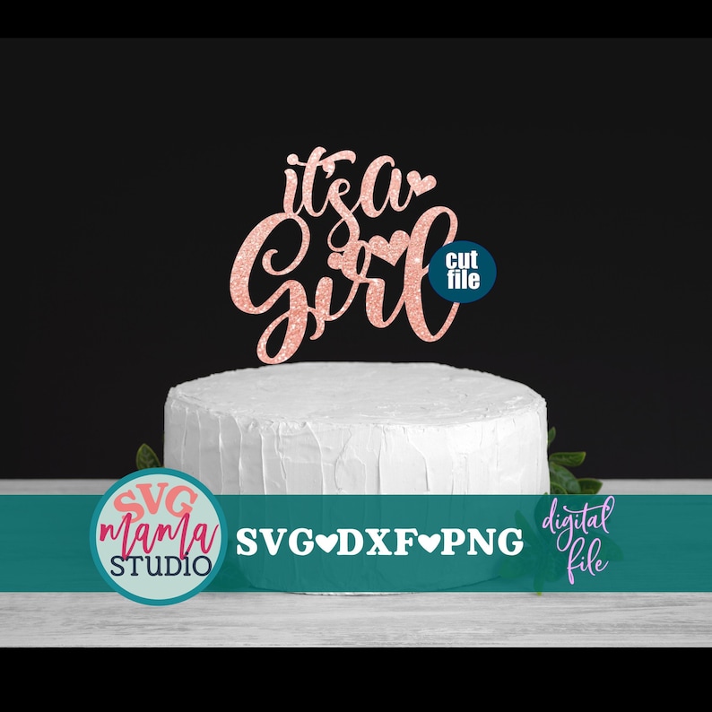 May include: A pink glitter cake topper with the text "it's a girl" and a heart. The topper is on a white cake. The text "cut file" is in a circle below the topper. The text "SVG mama STUDIO SVG&hearts;DXF&hearts;PNG digital file" is below the cake.