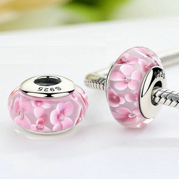 Pink glass beads and a silver charm for bottle bracelet