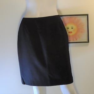 May include: A black knee-length skirt with a straight silhouette.