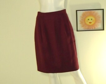 May include: A burgundy skirt with a straight cut and a simple design. The skirt is made of a smooth, wrinkle-resistant fabric.