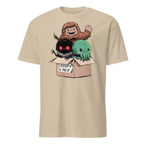 Adopt a Cryptid Shirt Funny Bigfoot Gifts for Monster Hunter Weird Stuff Folk Horror Shirt Sand
