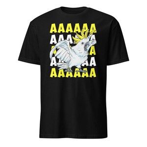 Vibrant red T-shirt featuring a cartoon sulfur-crested cockatoo screaming with its wings spread against a background of repeating "AAAAAA" text, ideal for bird owners, parrot lovers, and fans of chaotic, loud-humor graphic apparel.
