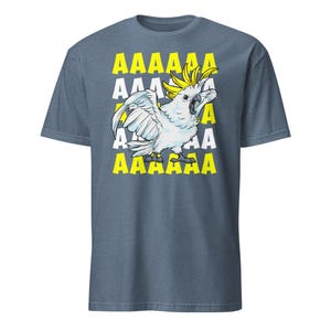 Vibrant red T-shirt featuring a cartoon sulfur-crested cockatoo screaming with its wings spread against a background of repeating "AAAAAA" text, ideal for bird owners, parrot lovers, and fans of chaotic, loud-humor graphic apparel.