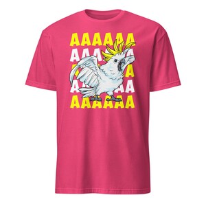 Vibrant red T-shirt featuring a cartoon sulfur-crested cockatoo screaming with its wings spread against a background of repeating "AAAAAA" text, ideal for bird owners, parrot lovers, and fans of chaotic, loud-humor graphic apparel.