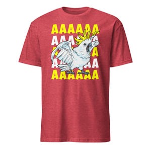 Vibrant red T-shirt featuring a cartoon sulfur-crested cockatoo screaming with its wings spread against a background of repeating "AAAAAA" text, ideal for bird owners, parrot lovers, and fans of chaotic, loud-humor graphic apparel.