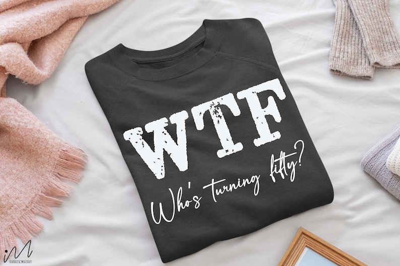 May include: A dark gray sweatshirt with the text "WTF Who's turning fifty?" printed in white.