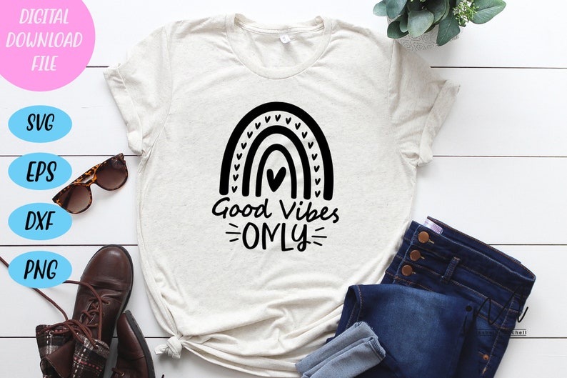 Peut inclure: Un t-shirt blanc avec un motif arc-en-ciel noir et le texte "Good Vibes Only".